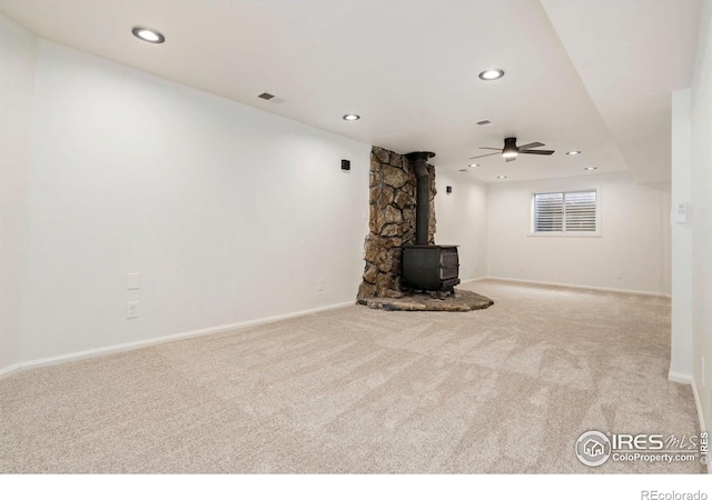 930 Vanderbilt Ct, Fort Collins, CO 80525 - unfurnished living room with a wood stove, carpet floors, and recessed lighting