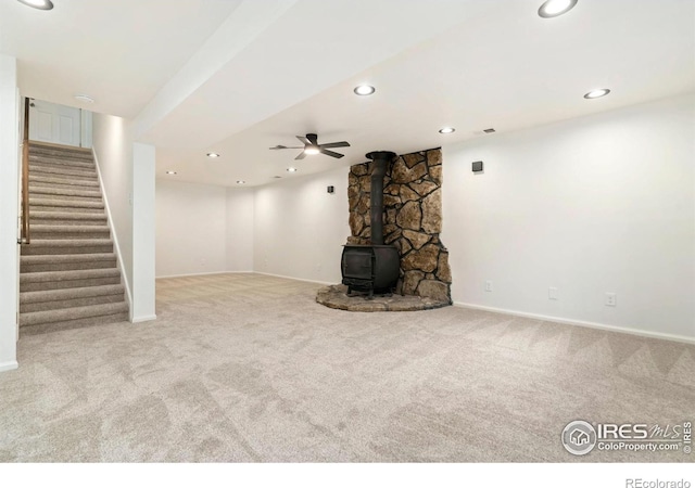 930 Vanderbilt Ct, Fort Collins, CO 80525 - unfurnished living room featuring carpet, a wood stove, stairway, and recessed lighting