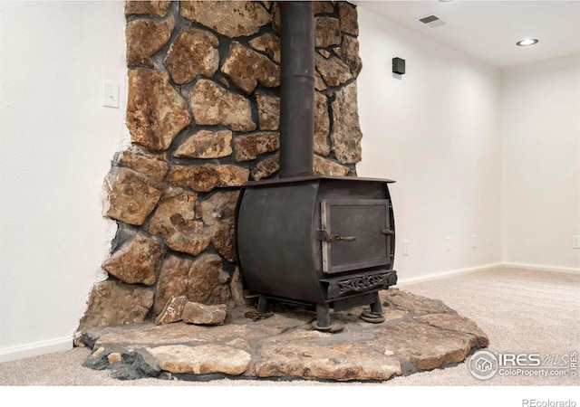 930 Vanderbilt Ct, Fort Collins, CO 80525 - detailed view of a wood stove, carpet floors, and recessed lighting