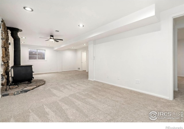 930 Vanderbilt Ct, Fort Collins, CO 80525 - unfurnished living room with carpet flooring, a wood stove, ceiling fan, and recessed lighting