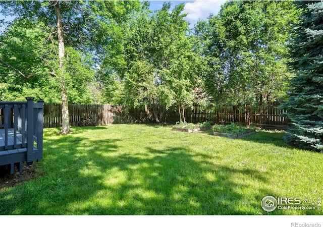 930 Vanderbilt Ct, Fort Collins, CO 80525 - fenced backyard with a vegetable garden and a wooden deck