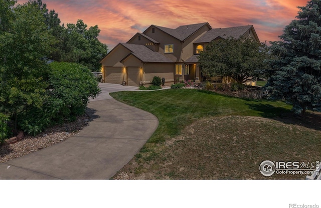 14652 Kalamath Ct, Westminster, CO 80023 - view of front facade with concrete driveway, a front yard, an attached garage, and stucco siding