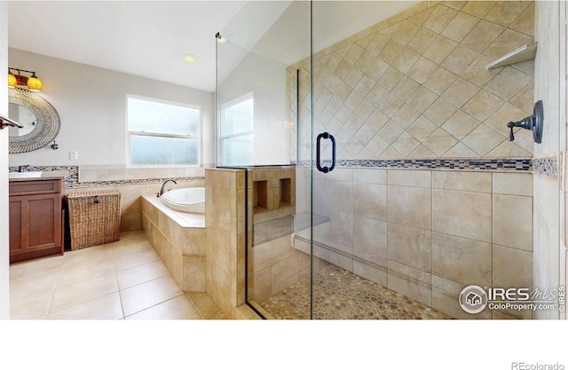 14652 Kalamath Ct, Westminster, CO 80023 - bathroom with vanity, a bath, a shower stall, and tile patterned flooring