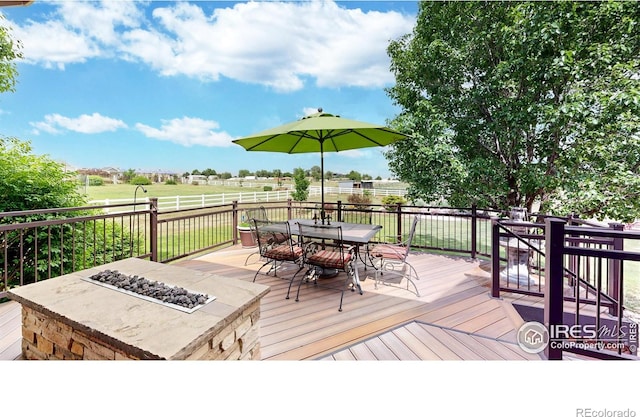 14652 Kalamath Ct, Westminster, CO 80023 - wooden terrace featuring an outdoor fire pit, outdoor dining area, and a fenced backyard
