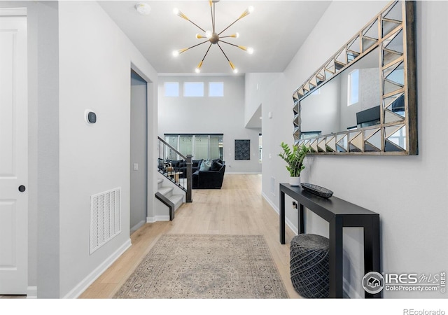 5056 Blanchette St, Timnath, CO 80547 - hall with a chandelier, wood finished floors, and stairs