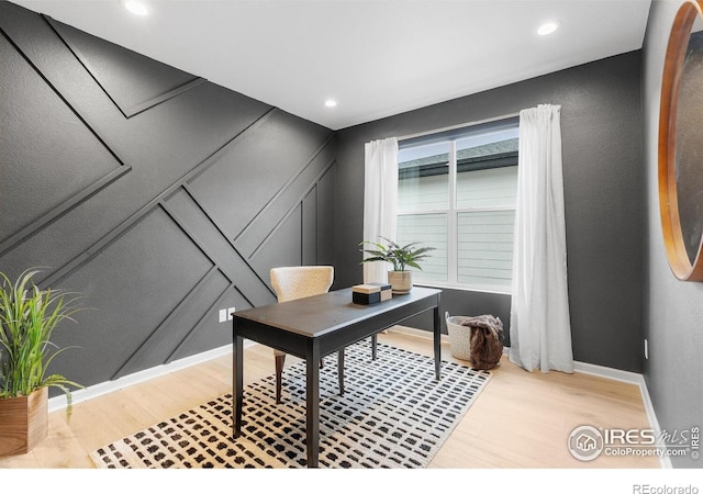 5056 Blanchette St, Timnath, CO 80547 - office featuring light wood finished floors, a decorative wall, and recessed lighting