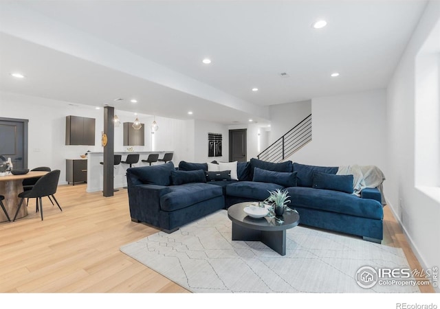 5056 Blanchette St, Timnath, CO 80547 - living area featuring light wood-type flooring, recessed lighting, and stairs