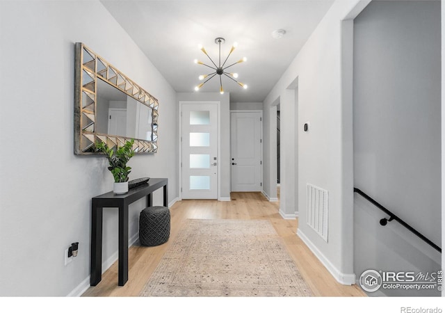 5056 Blanchette St, Timnath, CO 80547 - foyer entrance featuring a chandelier and wood finished floors