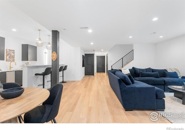 5056 Blanchette St, Timnath, CO 80547 - living room with light wood-style flooring, stairs, and recessed lighting