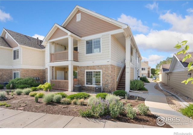 4905 Hahns Peak Dr Unit 202, Loveland, CO 80538 - view of front of home with stone siding, a balcony, and stairway