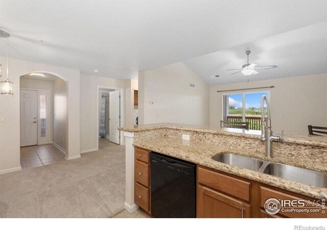 4905 Hahns Peak Dr Unit 202, Loveland, CO 80538 - kitchen with dishwasher, arched walkways, light colored carpet, brown cabinetry, and light stone counters
