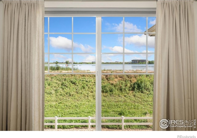4905 Hahns Peak Dr Unit 202, Loveland, CO 80538 - doorway to outside featuring a water view