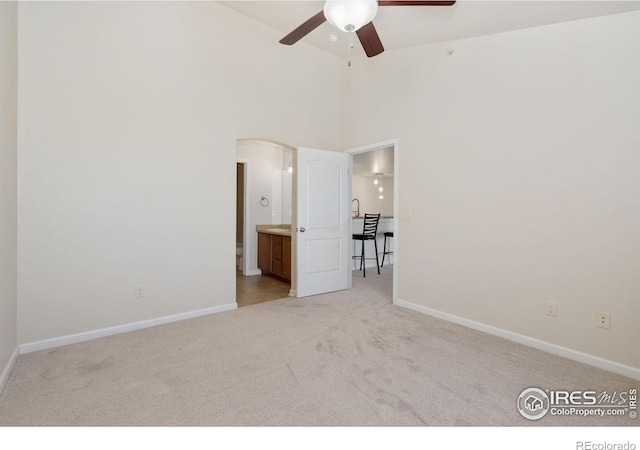 4905 Hahns Peak Dr Unit 202, Loveland, CO 80538 - unfurnished bedroom with carpet floors, ensuite bathroom, and a towering ceiling