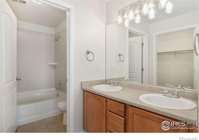 4905 Hahns Peak Dr Unit 202, Loveland, CO 80538 - bathroom with double vanity, tub / shower combination, and a walk in closet