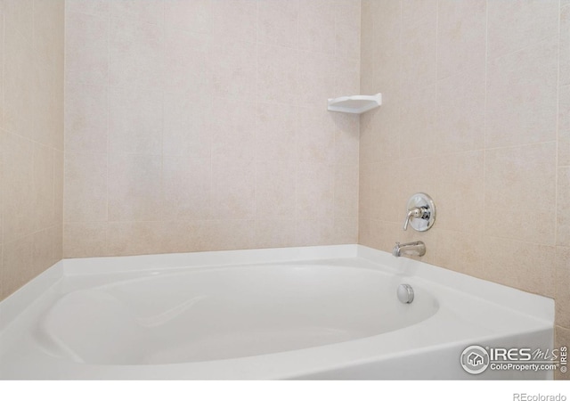 4905 Hahns Peak Dr Unit 202, Loveland, CO 80538 - bathroom featuring a tub and tile walls