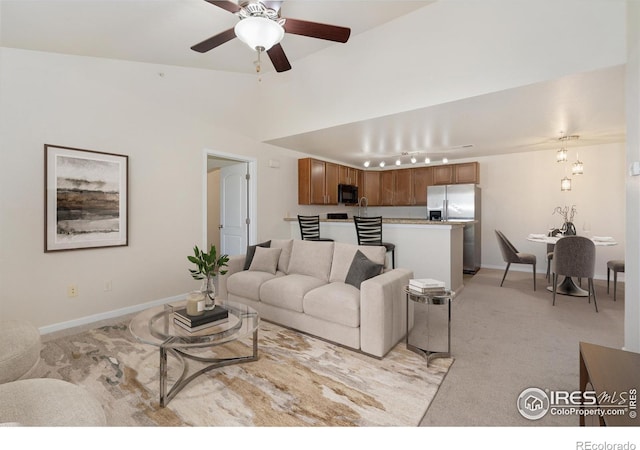 4905 Hahns Peak Dr Unit 202, Loveland, CO 80538 - living area with light colored carpet, a ceiling fan, and vaulted ceiling