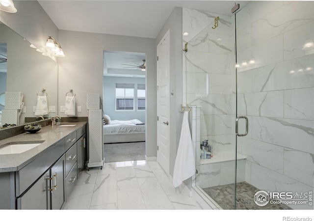 12917 Fox St, Westminster, CO 80234 - ensuite bathroom featuring double vanity, marble finish floors, ceiling fan, and a marble finish shower