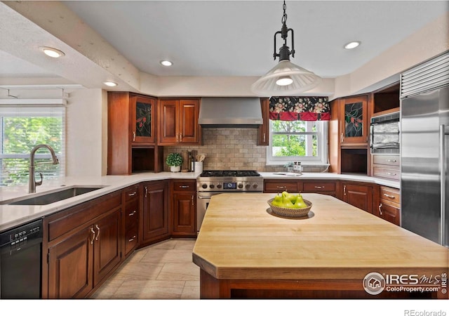 412 Terry Point Dr, Fort Collins, CO 80524 - kitchen with wall chimney range hood, premium appliances, recessed lighting, tasteful backsplash, and wooden counters