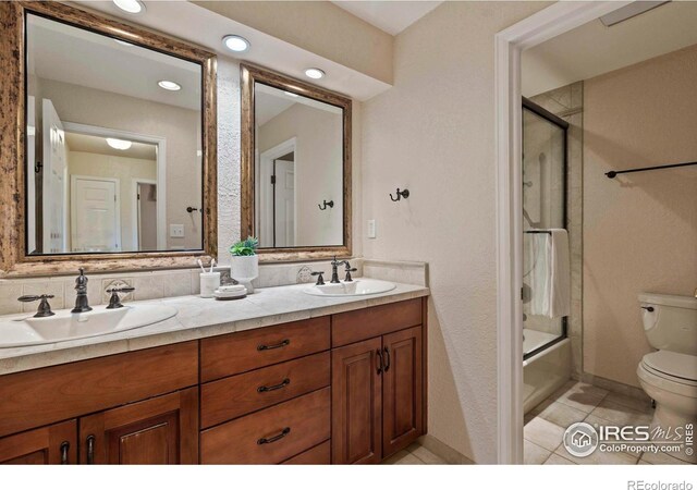 412 Terry Point Dr, Fort Collins, CO 80524 - full bathroom featuring double vanity, combined bath / shower with glass door, tile patterned flooring, and recessed lighting