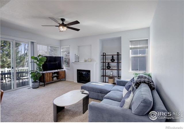 2547 Concord Cir, Lafayette, CO 80026 - living room featuring carpet flooring, ceiling fan, and a glass covered fireplace