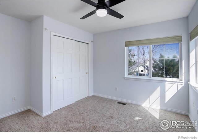 2547 Concord Cir, Lafayette, CO 80026 - unfurnished bedroom with carpet floors, a ceiling fan, and a closet