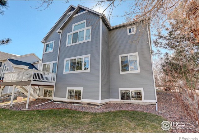 2547 Concord Cir, Lafayette, CO 80026 - back of property featuring a deck and a lawn