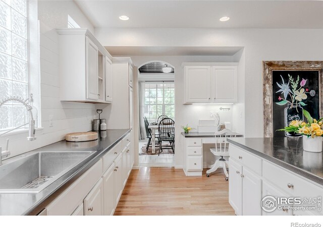 8367 Devinney St, Arvada, CO 80005 - kitchen with white cabinetry, light wood-type flooring, dark countertops, and recessed lighting