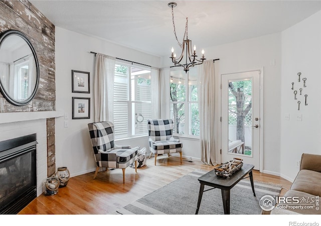 8367 Devinney St, Arvada, CO 80005 - living room with plenty of natural light, a chandelier, wood finished floors, and a fireplace