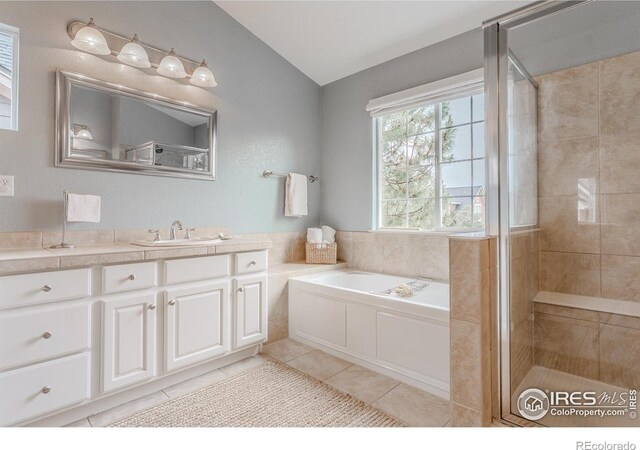 8367 Devinney St, Arvada, CO 80005 - full bathroom featuring vaulted ceiling, tile patterned flooring, vanity, a bath, and a shower stall