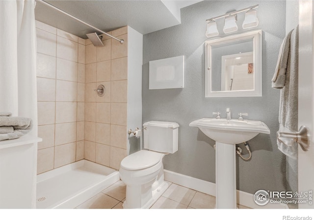 8367 Devinney St, Arvada, CO 80005 - full bathroom featuring tile patterned floors and a tile shower