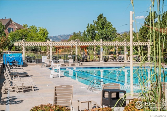 8367 Devinney St, Arvada, CO 80005 - community pool featuring a pergola, a mountain view, and a patio