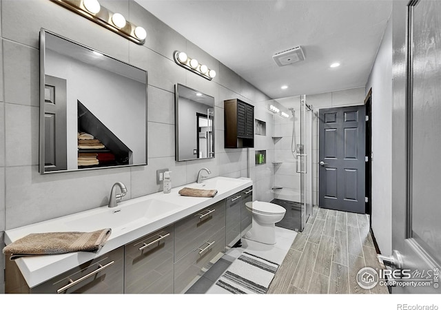 1424 Sheep Ridge Rd, Fairplay, CO 80440 - bathroom featuring double vanity, a shower stall, recessed lighting, and tile walls