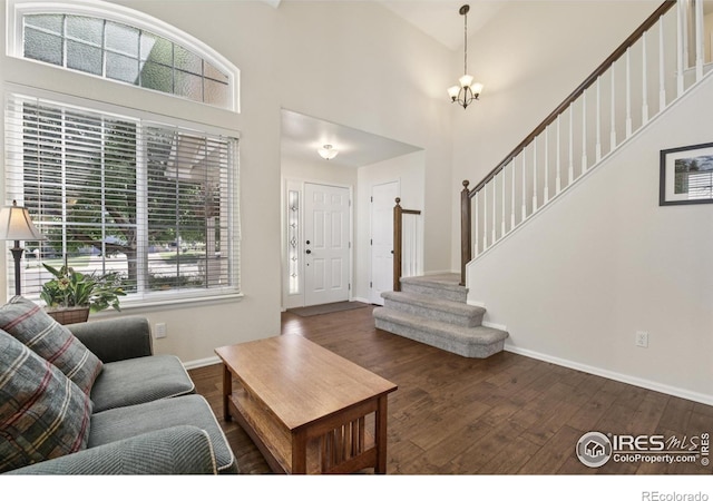 2608 E 132nd Ave, Thornton, CO 80241 - entrance foyer featuring stairs, wood finished floors, a high ceiling, and a chandelier