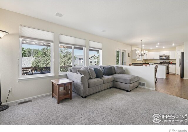 2608 E 132nd Ave, Thornton, CO 80241 - carpeted living area with a chandelier and baseboards