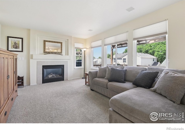 2608 E 132nd Ave, Thornton, CO 80241 - carpeted living area with a tile fireplace