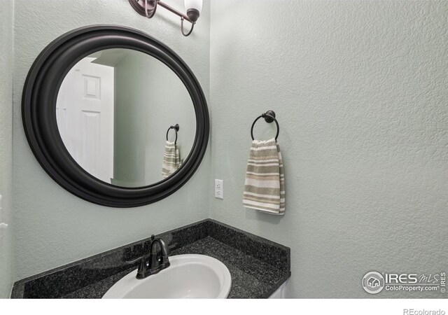 2608 E 132nd Ave, Thornton, CO 80241 - bathroom featuring vanity and a textured wall