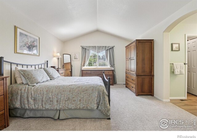 2608 E 132nd Ave, Thornton, CO 80241 - bedroom with arched walkways, lofted ceiling, and light carpet
