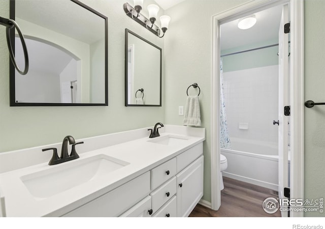 2608 E 132nd Ave, Thornton, CO 80241 - bathroom featuring wood finished floors, double vanity, and shower / bath combo