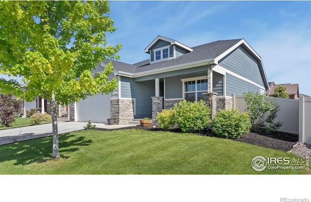 627 Overland Trl, Ault, CO 80610 - craftsman inspired home with stone siding, concrete driveway, an attached garage, and a porch