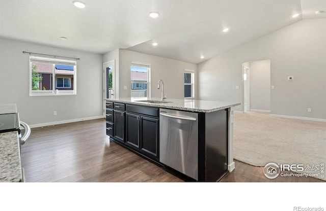 627 Overland Trl, Ault, CO 80610 - kitchen featuring dishwasher, healthy amount of natural light, vaulted ceiling, dark cabinetry, and a kitchen island with sink