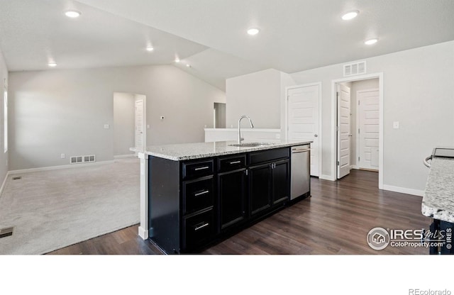 627 Overland Trl, Ault, CO 80610 - kitchen with dark cabinetry, dark wood-type flooring, dishwasher, lofted ceiling, and an island with sink