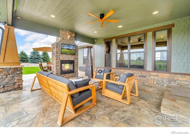 37021 Kingfisher Ct, Severance, CO 80550 - view of patio featuring an outdoor living space with a fireplace and ceiling fan