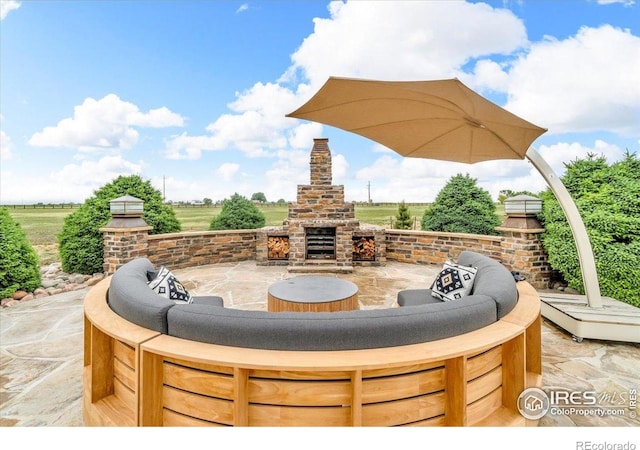 37021 Kingfisher Ct, Severance, CO 80550 - view of patio featuring an outdoor brick fireplace