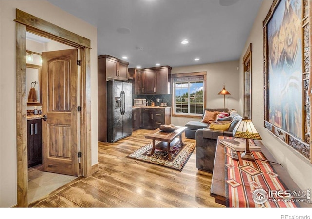 37021 Kingfisher Ct, Severance, CO 80550 - living area featuring light wood finished floors and recessed lighting