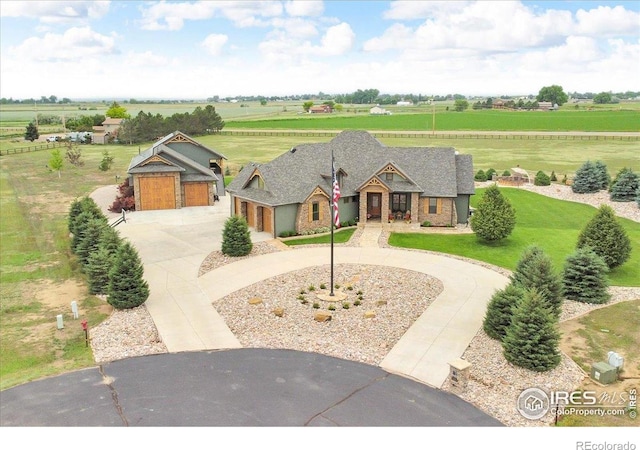 37021 Kingfisher Ct, Severance, CO 80550 - view of front of home with curved driveway, a view of countryside, stone siding, and an attached garage