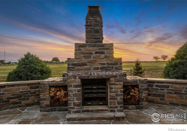 37021 Kingfisher Ct, Severance, CO 80550 - view of patio / terrace featuring an outdoor fireplace