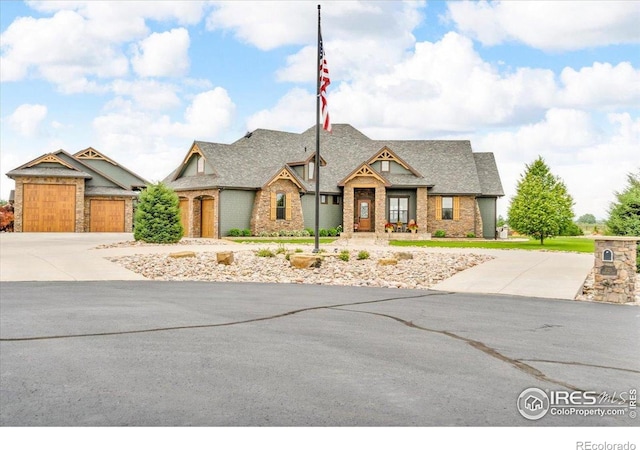 37021 Kingfisher Ct, Severance, CO 80550 - view of front of house featuring concrete driveway, brick siding, roof with shingles, and a garage