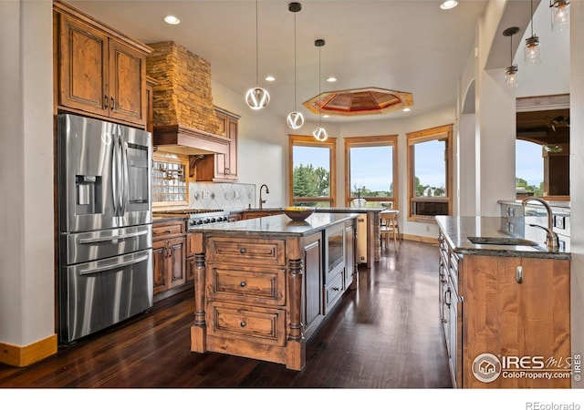 863 Riparian Way, Fort Collins, CO 80524 - kitchen featuring stainless steel fridge with ice dispenser, dark stone counters, dark wood-style floors, brown cabinets, and tasteful backsplash