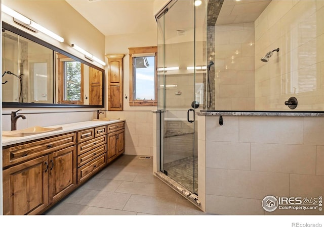 863 Riparian Way, Fort Collins, CO 80524 - bathroom with a shower stall, double vanity, and tile patterned floors
