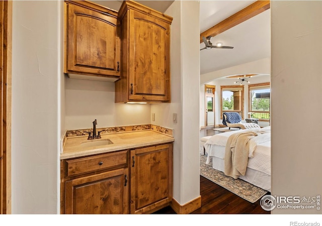 863 Riparian Way, Fort Collins, CO 80524 - kitchen with dark wood-style flooring, light countertops, a ceiling fan, arched walkways, and brown cabinetry